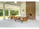 Outdoor picnic area with brick fireplace and wooden tables at 2972 Anchor Watch Dr, Wadmalaw Island, SC 29487