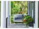 Gray porch swing on a spacious front porch with lush greenery at 2972 Anchor Watch Dr, Wadmalaw Island, SC 29487