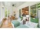 Sunroom with hardwood floors, seating, and access to kitchen at 2972 Anchor Watch Dr, Wadmalaw Island, SC 29487