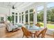 Sunroom with hardwood floors, wicker furniture, and abundant natural light at 2972 Anchor Watch Dr, Wadmalaw Island, SC 29487