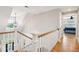 Upstairs hallway with hardwood floors and a view into a bedroom at 2972 Anchor Watch Dr, Wadmalaw Island, SC 29487