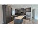 Modern kitchen with gray cabinets, stainless steel appliances, and an island at 392 Dike Rd, Bonneau, SC 29431