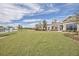 Well-manicured lawn leading to a clubhouse with a beautiful pond at 506 Tranquil Waters Way, Summerville, SC 29486