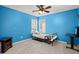 Small bedroom with blue walls, full-size bed, and a desk at 1005 Shinnecock Hills Ct, Summerville, SC 29483