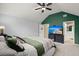 Spacious bedroom with green accent wall, large TV, and en-suite bathroom at 1005 Shinnecock Hills Ct, Summerville, SC 29483