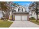 Two-story brick home with a two-car garage and well-manicured lawn at 1005 Shinnecock Hills Ct, Summerville, SC 29483