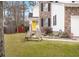Landscaped yard with wooden chairs and a walkway to the front door at 1005 Shinnecock Hills Ct, Summerville, SC 29483