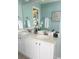Double vanity bathroom with light teal walls and white cabinets at 1005 Washitonia # C, Charleston, SC 29492