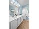 Double vanity bathroom with light blue walls and updated fixtures at 1005 Washitonia # C, Charleston, SC 29492