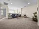Open living area with gray sofa, carpeted floor, and natural light at 1005 Washitonia # C, Charleston, SC 29492