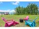 Spacious backyard with firepit and colorful chairs at 1016 Swamp Harrier Ave, Ravenel, SC 29470