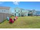 Large backyard with patio and colorful adirondack chairs at 1016 Swamp Harrier Ave, Ravenel, SC 29470
