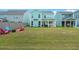 Large backyard with patio and colorful adirondack chairs at 1016 Swamp Harrier Ave, Ravenel, SC 29470