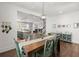 Dining room with kitchen view and hardwood floors at 1016 Swamp Harrier Ave, Ravenel, SC 29470