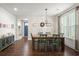 Dining room with farmhouse table and chairs, and floral wallpaper at 1016 Swamp Harrier Ave, Ravenel, SC 29470