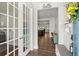 Bright entryway with hardwood floors and view into kitchen at 1016 Swamp Harrier Ave, Ravenel, SC 29470