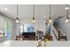 Open concept kitchen with island seating and a view into the living room at 1016 Swamp Harrier Ave, Ravenel, SC 29470