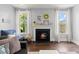 Comfortable living room featuring a fireplace and plenty of natural light at 1016 Swamp Harrier Ave, Ravenel, SC 29470