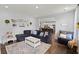 Spacious living room with sectional sofa, open to kitchen, and hardwood floors at 1016 Swamp Harrier Ave, Ravenel, SC 29470