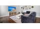 Gathering room with sectional sofa, large TV, and hardwood floors at 1016 Swamp Harrier Ave, Ravenel, SC 29470