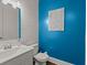 Stylish powder room with blue accent wall at 1016 Swamp Harrier Ave, Ravenel, SC 29470
