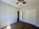 Cozy bedroom with neutral paint, wood-look floors, a ceiling fan, and a spacious closet at 1081 Irving Manigault Rd, McClellanville, SC 29458