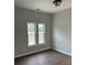 This bedroom features neutral paint, a light fixture and a pair of windows at 1081 Irving Manigault Rd, McClellanville, SC 29458