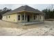 Rear view of new construction home showcasing covered patio at 1081 Irving Manigault Rd, McClellanville, SC 29458