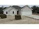 Charming single-story home with a two-car garage and a red front door at 1081 Irving Manigault Rd, McClellanville, SC 29458