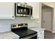 Bright, new kitchen featuring white cabinets, stainless steel microwave and range, with marble countertops at 1081 Irving Manigault Rd, McClellanville, SC 29458