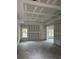 Spacious living room with drywall and new windows at 1081 Irving Manigault Rd, McClellanville, SC 29458