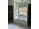 Bathroom with a bathtub and window overlooking the backyard at 1085 Irving Manigault Rd, McClellanville, SC 29458