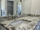 Bathroom features a double sink, granite countertops, and ample mirror space at 1085 Irving Manigault Rd, McClellanville, SC 29458