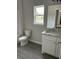 Bathroom showcasing a vanity with sink, toilet, and window for natural light at 1085 Irving Manigault Rd, McClellanville, SC 29458
