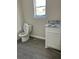 New bathroom features a toilet, vanity with a sink, and window for natural light at 1085 Irving Manigault Rd, McClellanville, SC 29458
