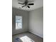 Bright bedroom featuring a ceiling fan and natural light from a window, ready for finishing touches at 1085 Irving Manigault Rd, McClellanville, SC 29458