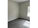 Bright bedroom featuring dark flooring and a window for natural light at 1085 Irving Manigault Rd, McClellanville, SC 29458