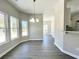 Bright dining room with new windows, modern light fixture, and vinyl flooring at 1085 Irving Manigault Rd, McClellanville, SC 29458