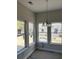 Dining room featuring a stylish chandelier and bright windows covered for protection during construction at 1085 Irving Manigault Rd, McClellanville, SC 29458