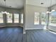 Adjacent dining rooms with lots of light, modern light fixtures, and vinyl flooring at 1085 Irving Manigault Rd, McClellanville, SC 29458