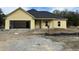 New construction home features a two-car garage and covered porch at 1085 Irving Manigault Rd, McClellanville, SC 29458