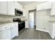 Kitchen featuring white cabinets, granite countertops, and stainless appliances at 1085 Irving Manigault Rd, McClellanville, SC 29458