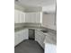 Kitchen featuring white cabinets, stainless steel dishwasher, and granite countertops at 1085 Irving Manigault Rd, McClellanville, SC 29458