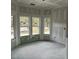 Bright living room with large windows and unfinished walls at 1085 Irving Manigault Rd, McClellanville, SC 29458