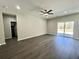 Spacious living room with vinyl floors, ceiling fan, recessed lighting, and sliding glass door at 1085 Irving Manigault Rd, McClellanville, SC 29458