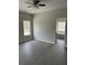 Main bedroom featuring dark flooring, ceiling fan, and view to attached bathroom at 1085 Irving Manigault Rd, McClellanville, SC 29458