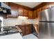 Efficient kitchen featuring dark wood cabinets and stainless steel appliances at 112 Sawmill Dr, Summerville, SC 29483