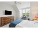Bright bedroom with a double bed, dresser, and large window at 130 River Landing Dr # 8203, Charleston, SC 29492