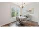Bright dining area with round table, four chairs, and a decorative mirror at 130 River Landing Dr # 8203, Charleston, SC 29492