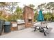 Outdoor grilling area with brick fireplace and picnic tables at 130 River Landing Dr # 8203, Charleston, SC 29492